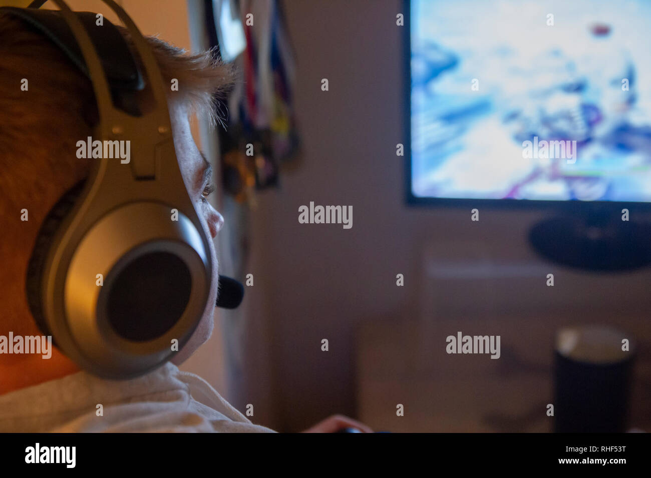 A teenaged boy playing computer games in his bedroom Stock Photo Alamy