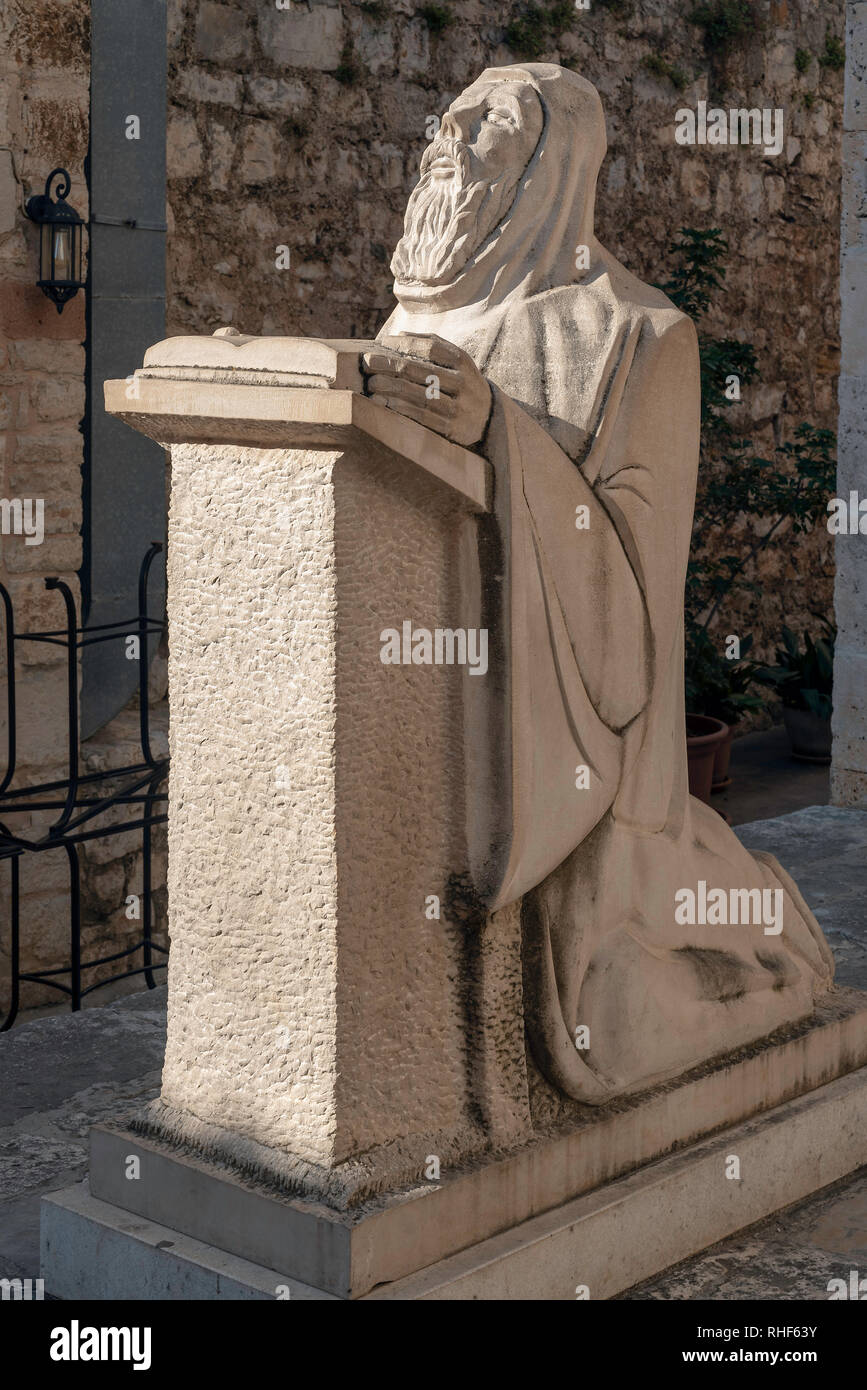 The statue of St. Anthony kneeling at prayer, Hvar Town, Croatia Stock Photo