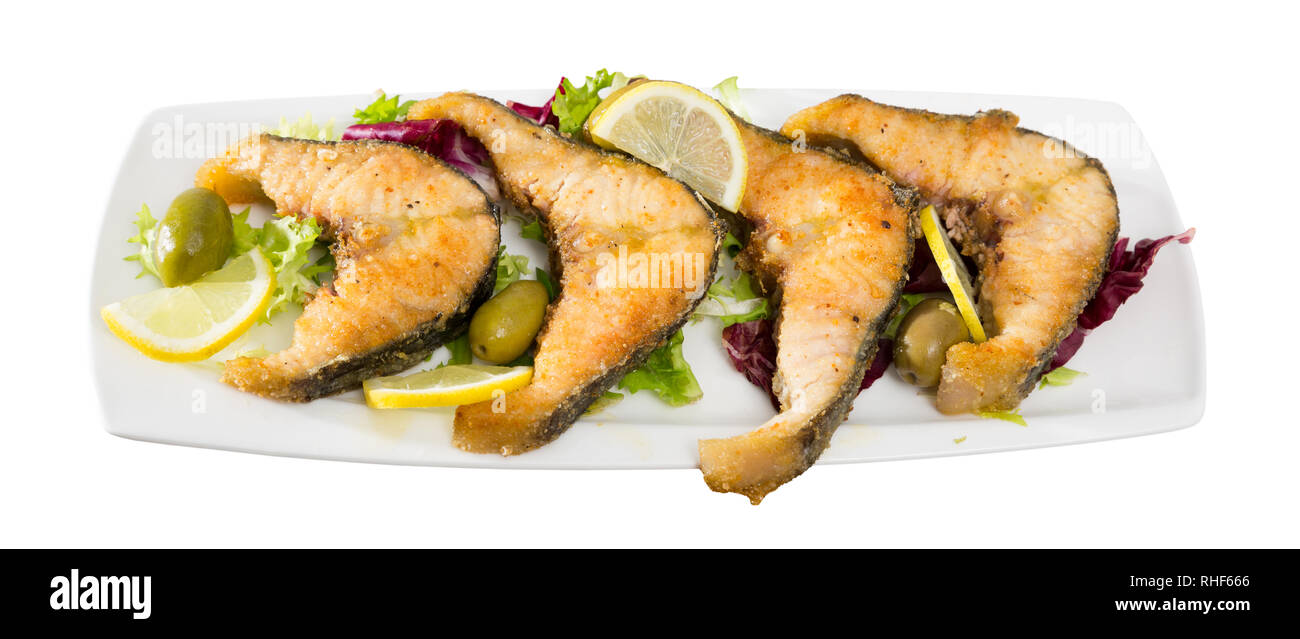 Tasty fish dish – roasted sturgeon fish served with lemon and ...