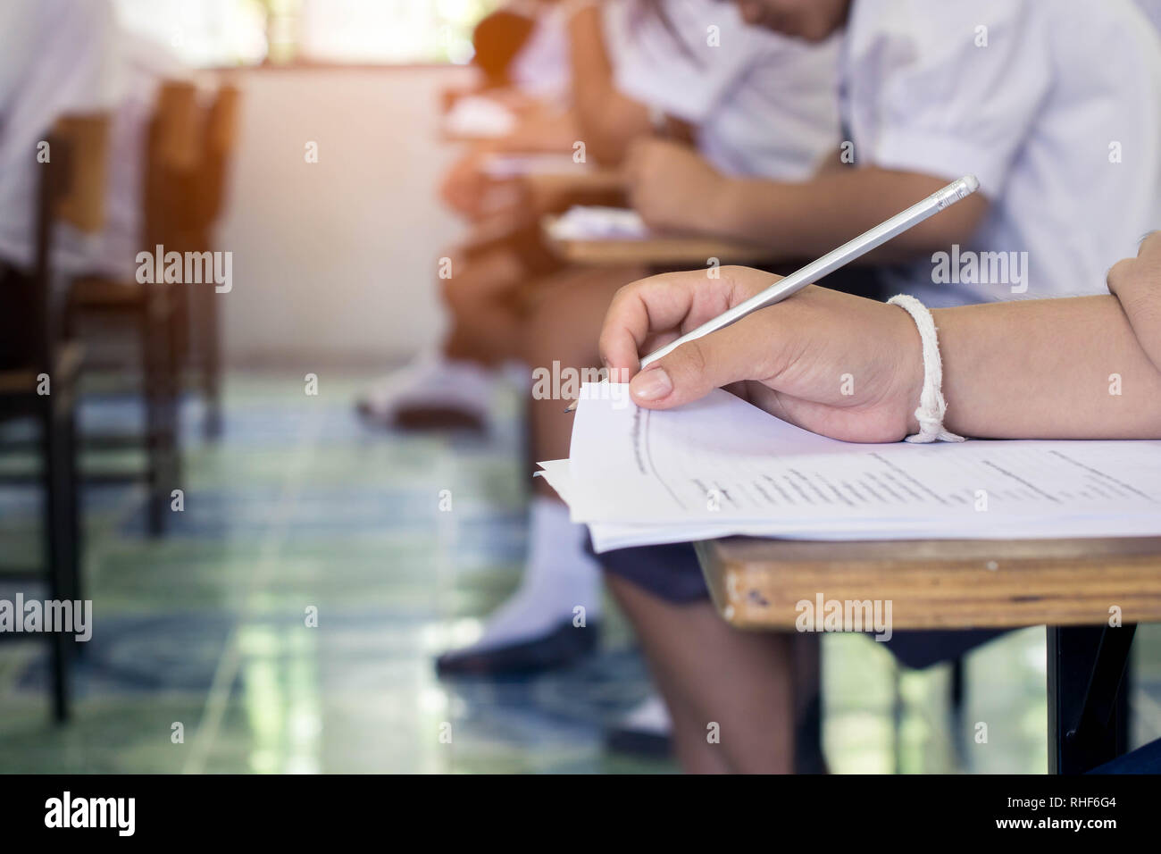 Close up hand of student reading and writing exam with stress Stock