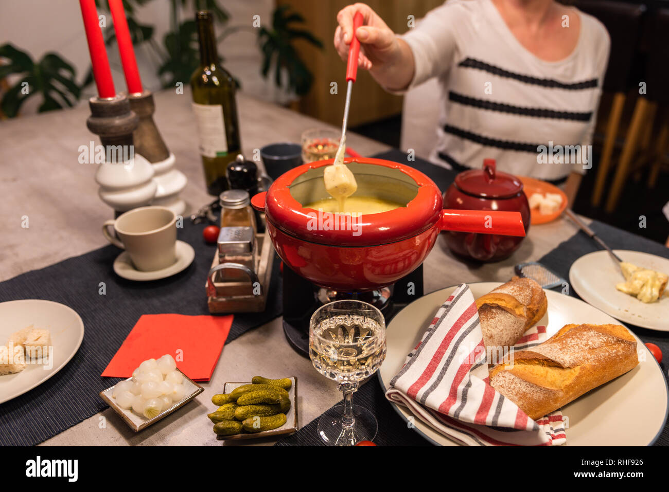 Traditional swiss cheese fondue in a red pot on concrete dining ...