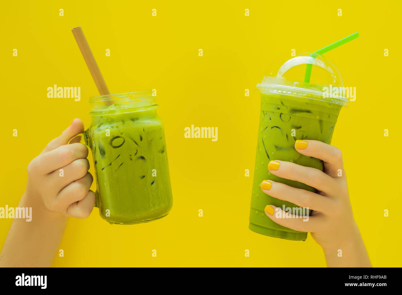 https://c8.alamy.com/comp/RHF9AB/green-tea-latte-with-ice-in-mason-jar-and-in-a-plastic-cup-in-hands-on-yellow-background-homemade-iced-matcha-latte-tea-with-milk-zero-waste-RHF9AB.jpg