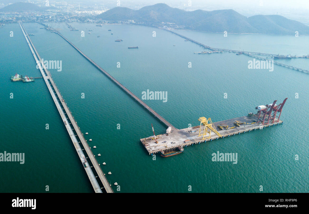 Aerial view of container ship in import - export business industry in Sriracha industrial port, Chonburi, Thailand. Stock Photo