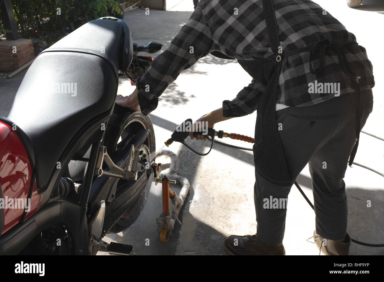 Cleaning motorbike with water Stock Photo Alamy