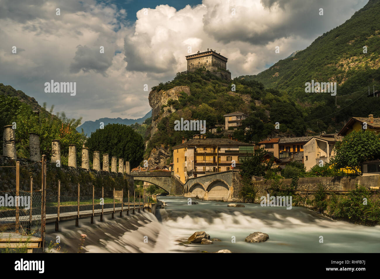 aosta old stone castle with river in north italy cloudy sky Stock Photo