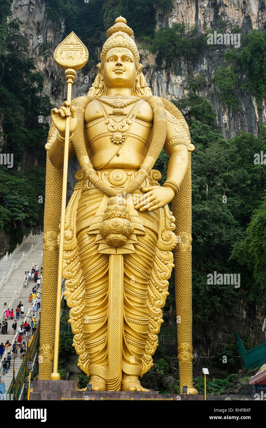 Kuala Lumpur Batu Caves, Selangor / Malaysia - July 21, 2018: Huge and golden Hindu statue of lord Murugan at Batu caves in Kuala Lumpur in Malaysia i Stock Photo