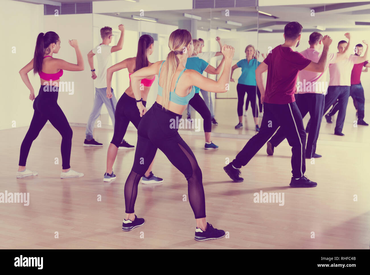 Smiling people of different ages dancing in  dance school Stock Photo