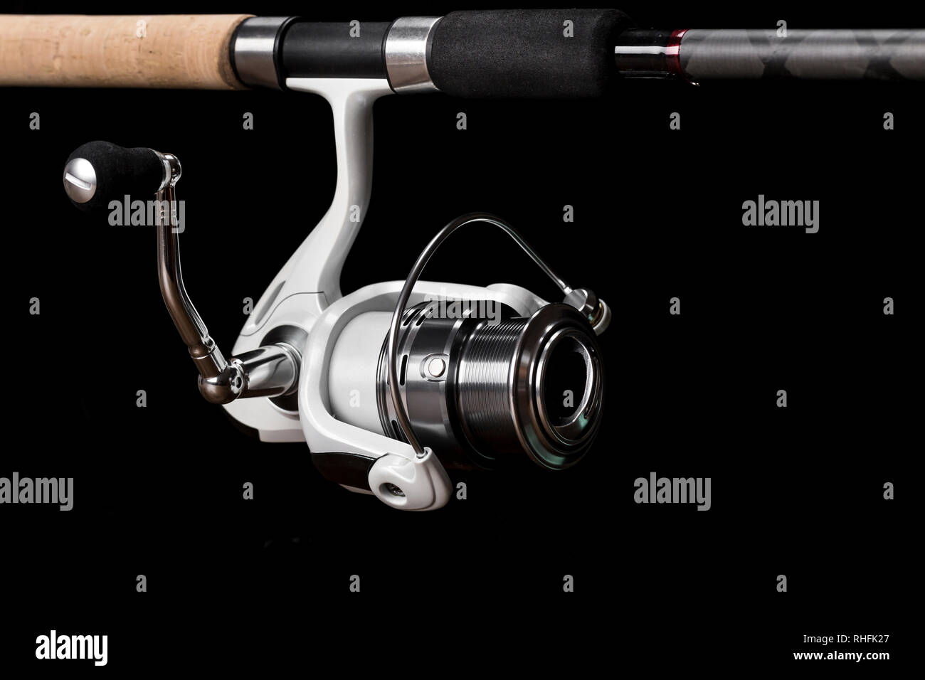 Fishing reel on black background. feeder spool for fishing Stock Photo -  Alamy