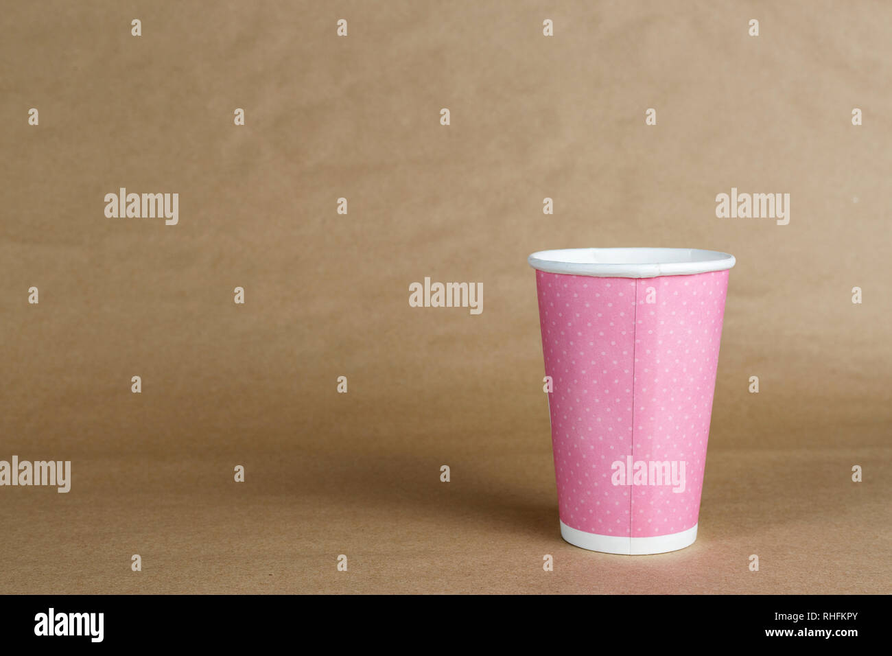 pink cardboard cup for coffee without a cover on a brown background Stock Photo Alamy