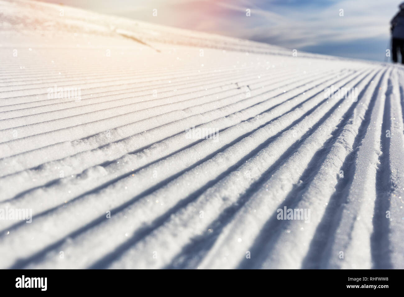 Close-up groomed snow at ski resort, slope banner background texture Stock Photo