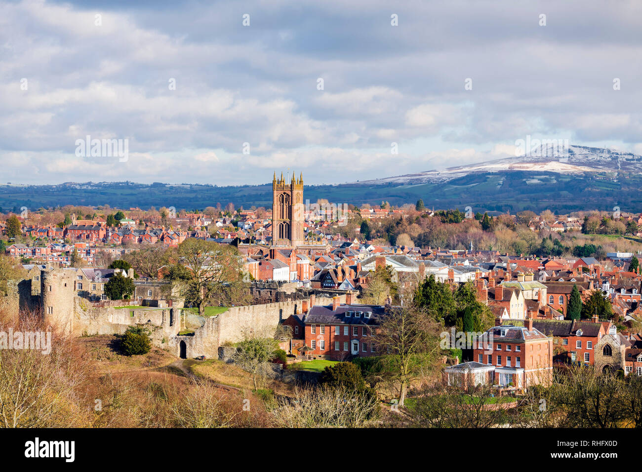 Ludlow Castle in winter, with a dusting of snow on the distant hills. Photo taken from Whitcliffe Common, overlooking the town, UK. Stock Photo