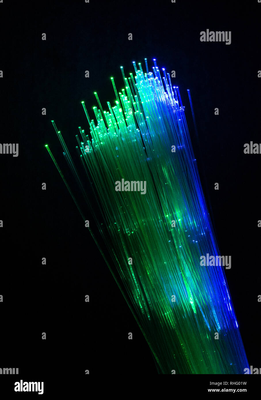 Colourful optic fibers illuminated on dark background. High speed ...