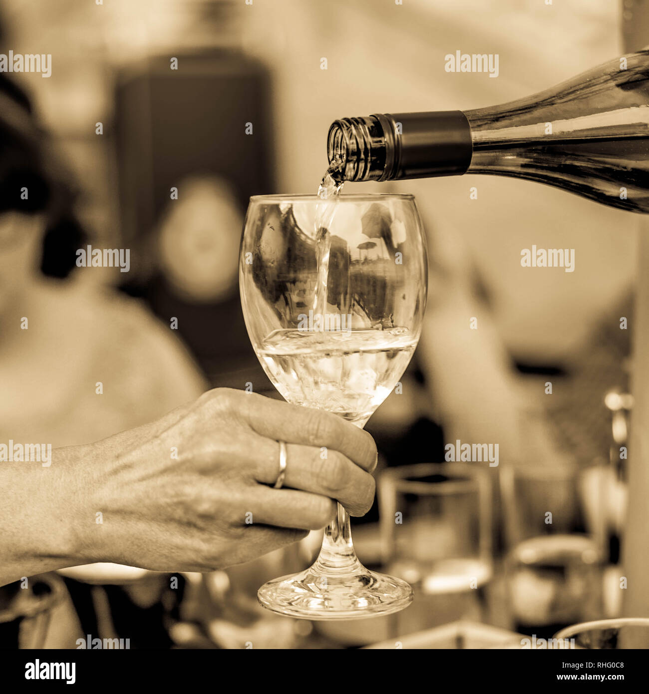 https://c8.alamy.com/comp/RHG0C8/toned-close-up-monochrome-image-of-pouring-wine-from-a-bottle-into-a-glass-RHG0C8.jpg