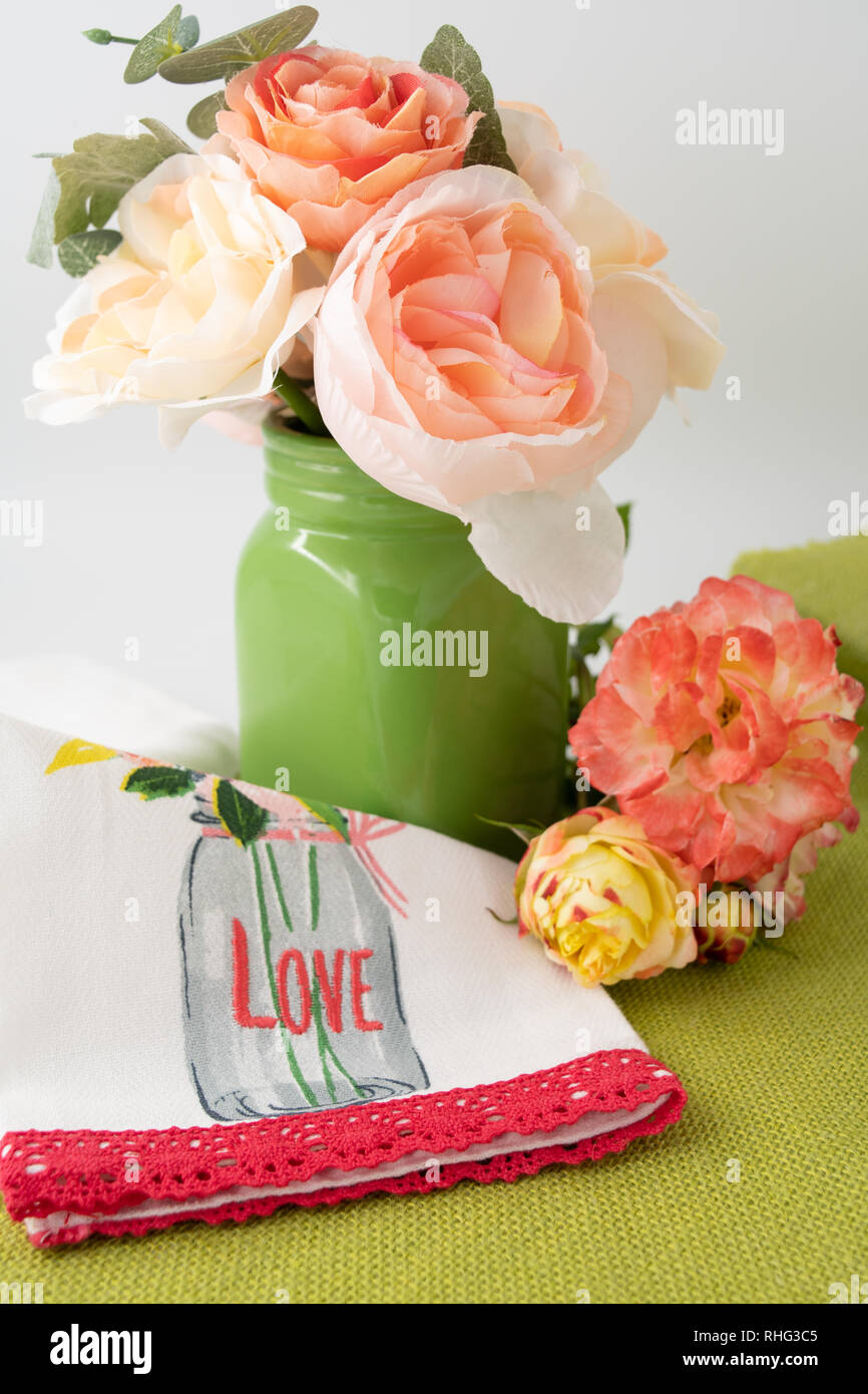 Valentine's Day cupcake in holiday paper with flowers in background