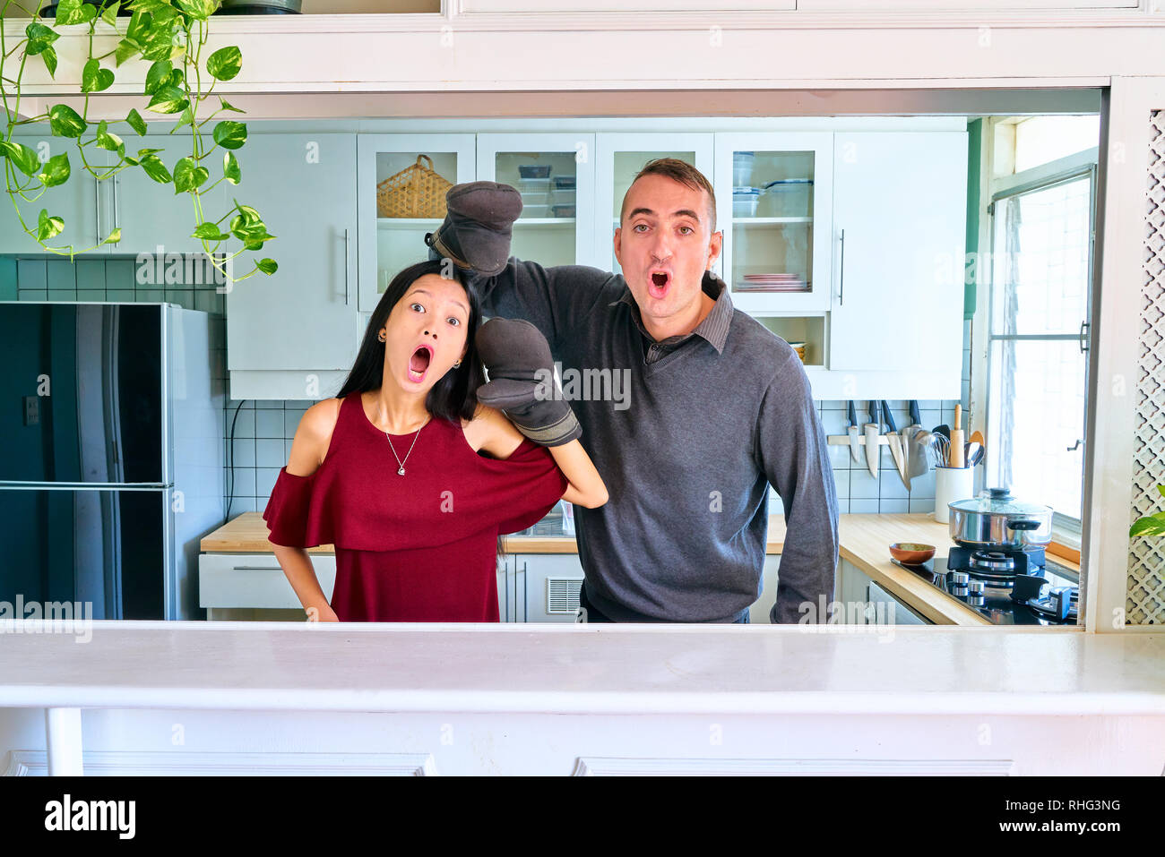 Lovely couple posing - playing the puppet hands and making a face Stock Photo
