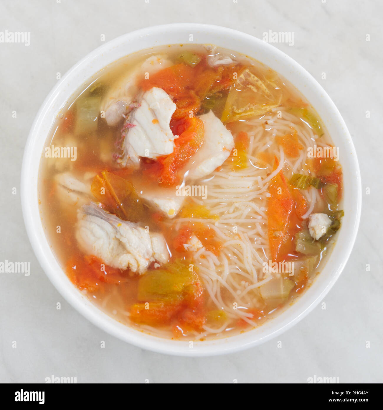 Malaysian delicious streets food a spicy fresh fish seafood Soup  on gravy hot tomyam with rice vermicelli  or rice noodles. Stock Photo
