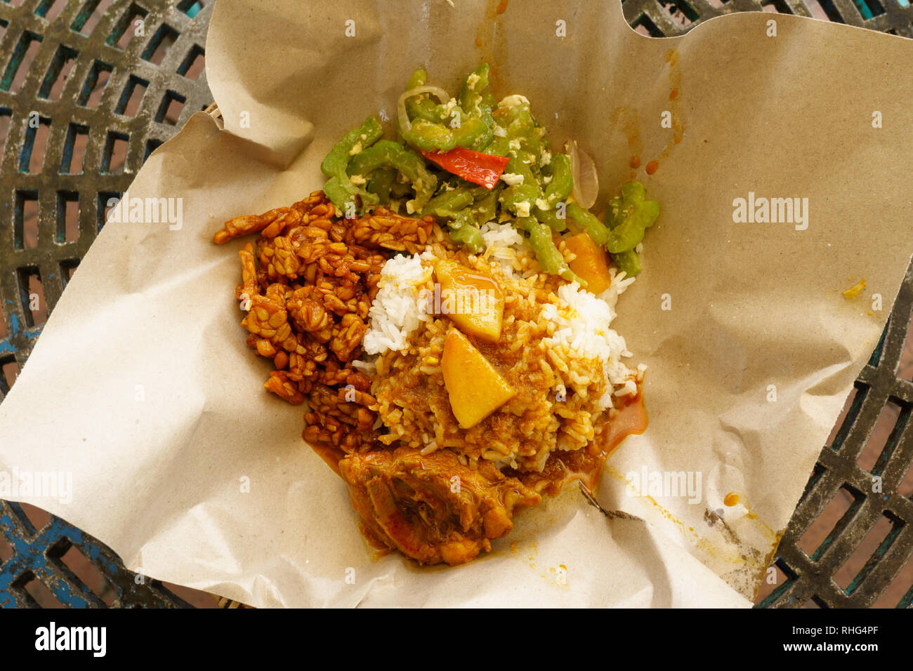 Typical Malaysian daily lunch called Nasi Campur or Nasi Bungkus which is loosely translated as rice mixed with vegetable, tempe, chicken or fish. Stock Photo