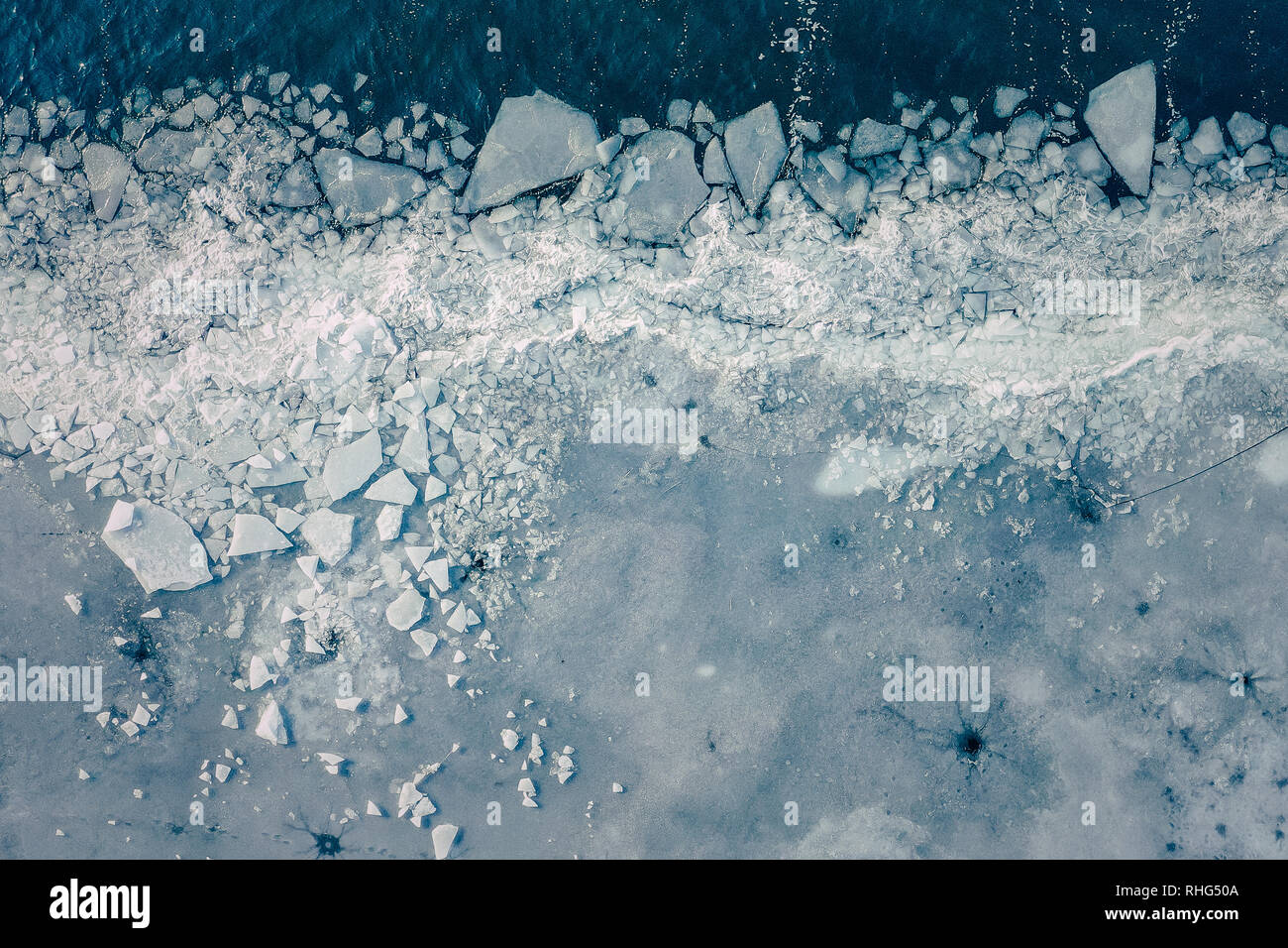 Glacier Lagoon with icebergs from above. Aerial View. Cracked Ice from drone view. Background texture concept. - Stock Image