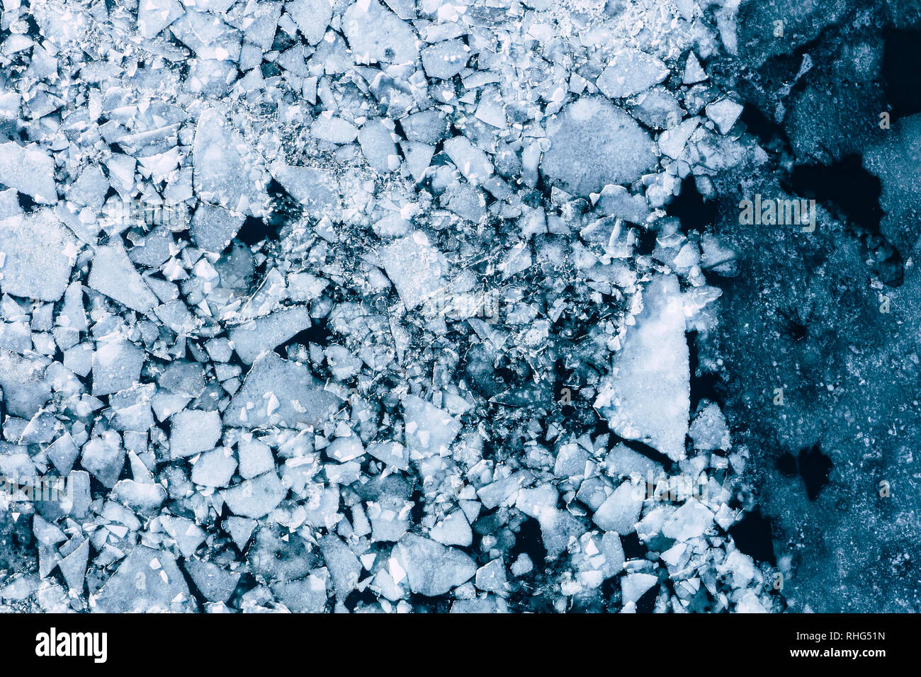 Glacier Lagoon with icebergs from above. Aerial View. Cracked Ice from drone view. Background texture concept. - Stock Image