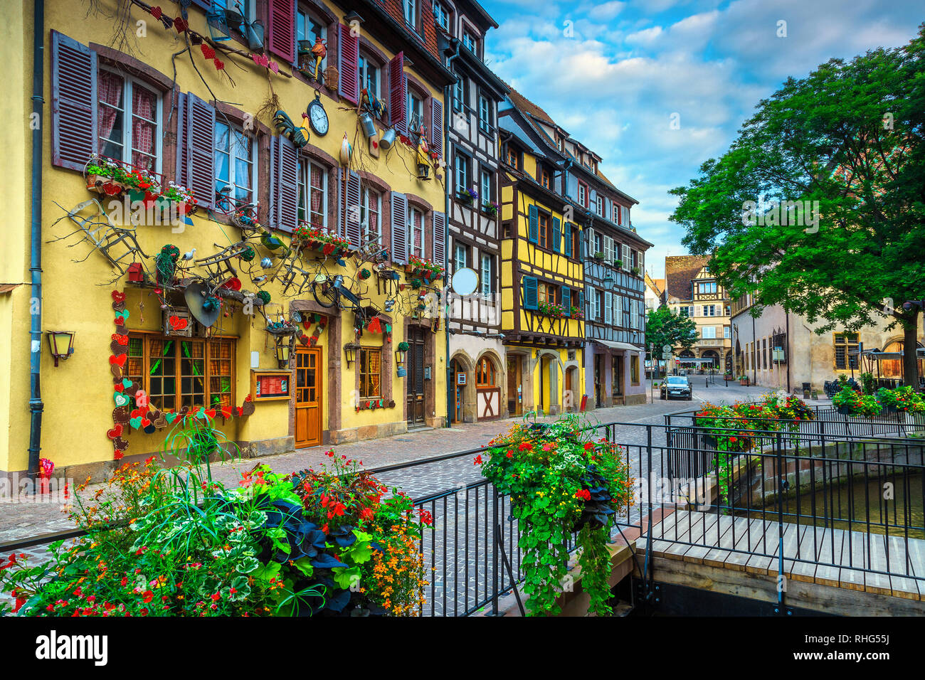 Fantastic travel destination, amazing colorful traditional French houses and decorated street with beautiful flowers, Colmar, France, Europe Stock Photo