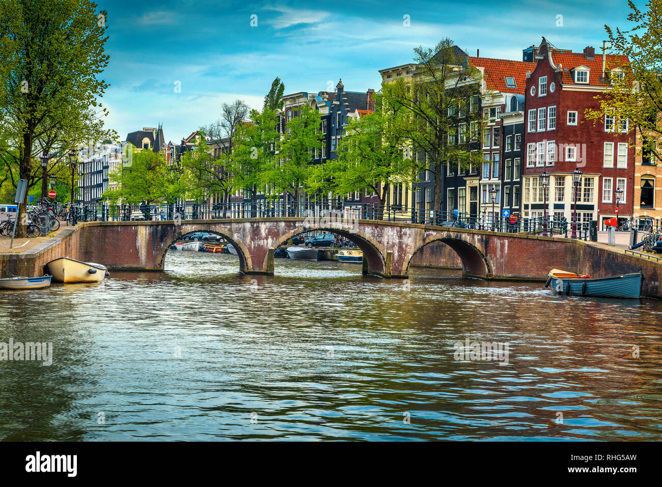 Fantastic travel and touristic destination, spectacular cityscape with traditional dutch houses. Water canal with boats and bridge over the river, Ams Stock Photo