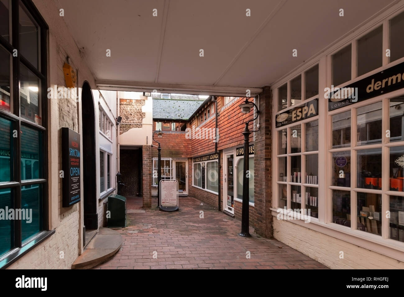 Urban view of Worthing, West Sussex, UK featuring an alleyway of shops Stock Photo
