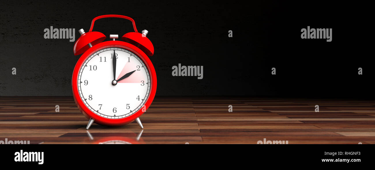European daylight saving time end. Red alarm clock on wooden desk