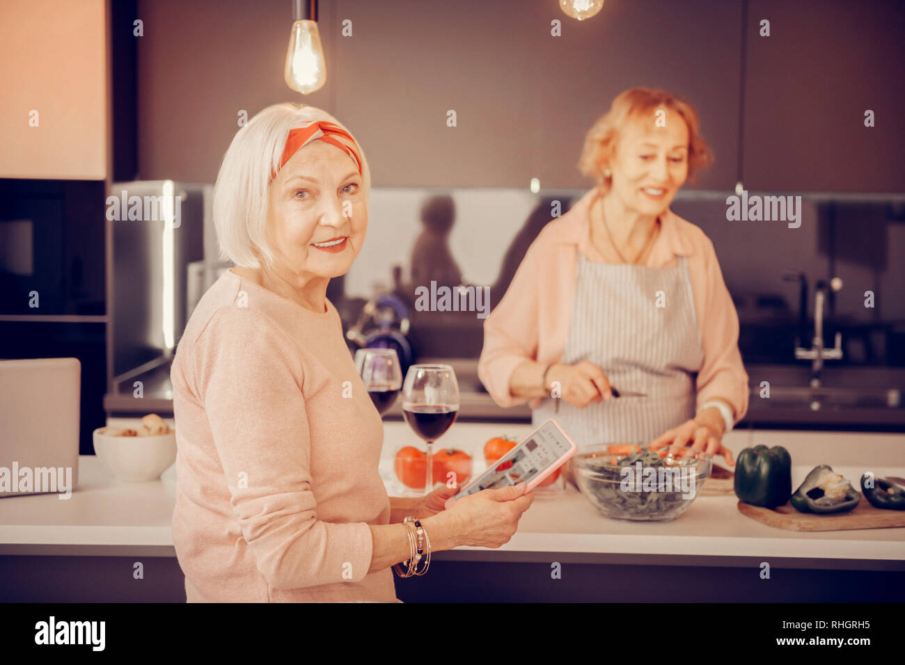Cheerful nice woman using a modern tablet Stock Photo