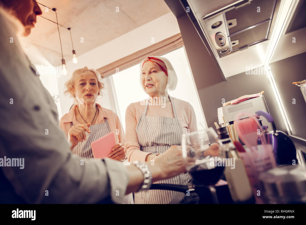 Positive nice aged women helping each other Stock Photo
