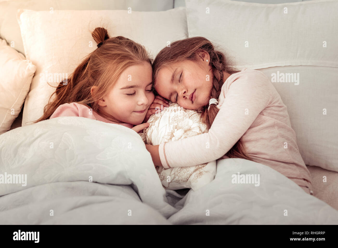 Beautiful cute sisters sleeping on the bed Stock Photo Alamy