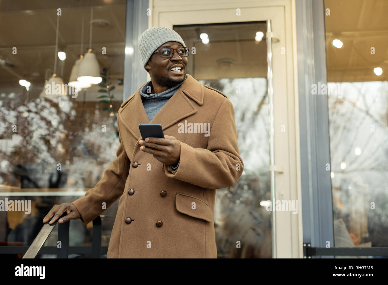 Beaming father waiting for his family near their favorite restaurant Stock Photo