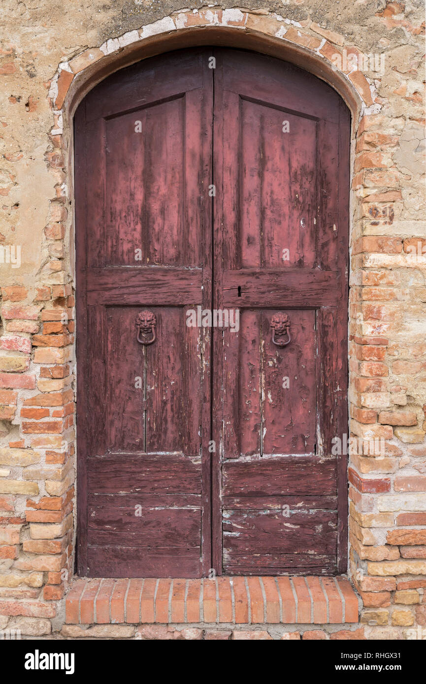 Old red painted doors in the backstreets of Florence, Italy Stock Photo