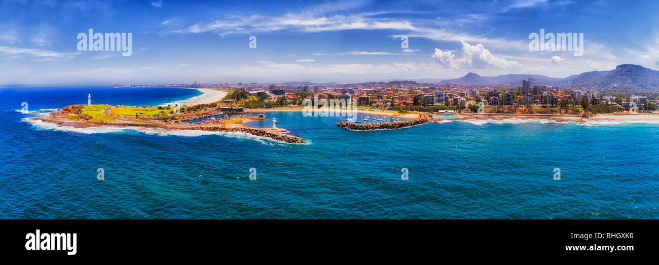 Coastal town Wollongong on Australian NSW South Coast seen from open sea towards waterfront with houses and streets around headland, lighthouses and h Stock Photo