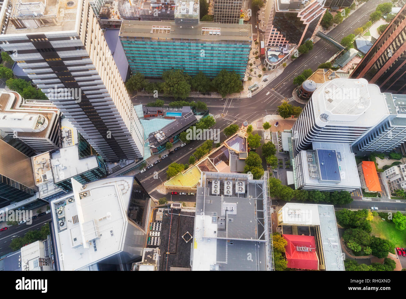 Intersection of transport highway and streets in the middle of city CBD between tall high-rise business towers - aerial elevated view top down. Stock Photo
