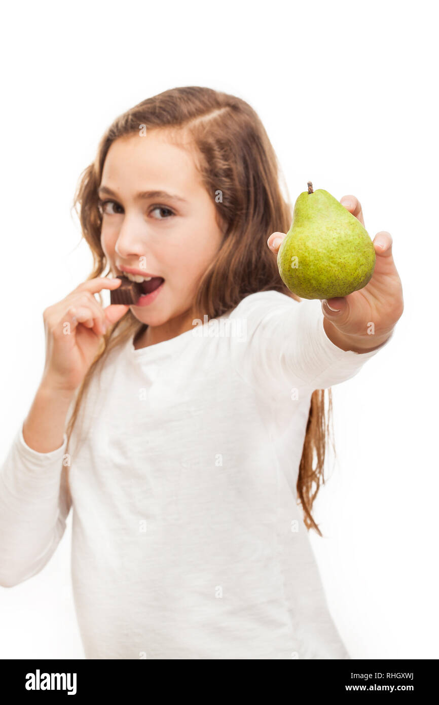 Young girl choosing between fruit and chocolate isolated on white background Stock Photo