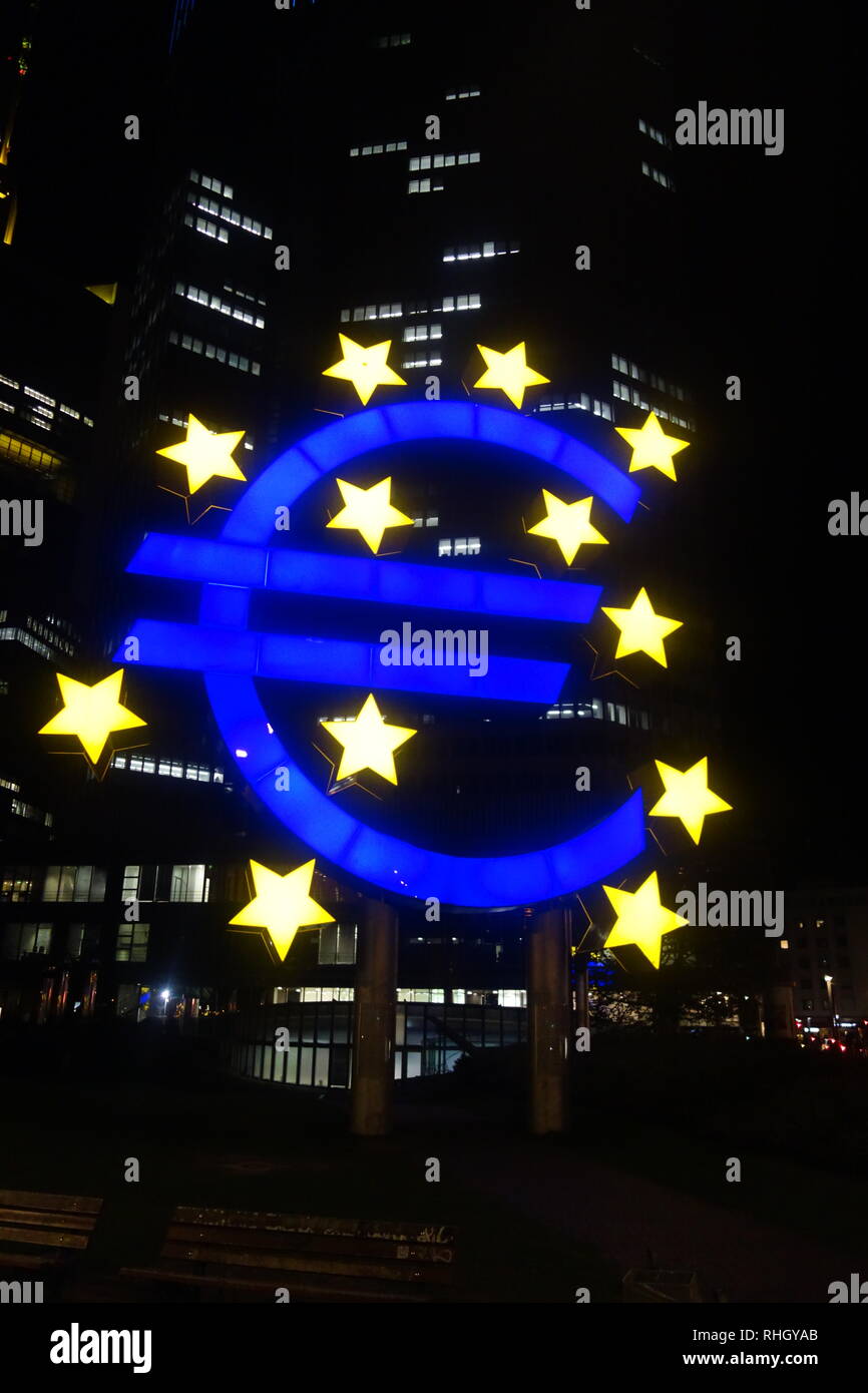 Illuminated Euro Sign sculpture at night outside the Eurotower building ...