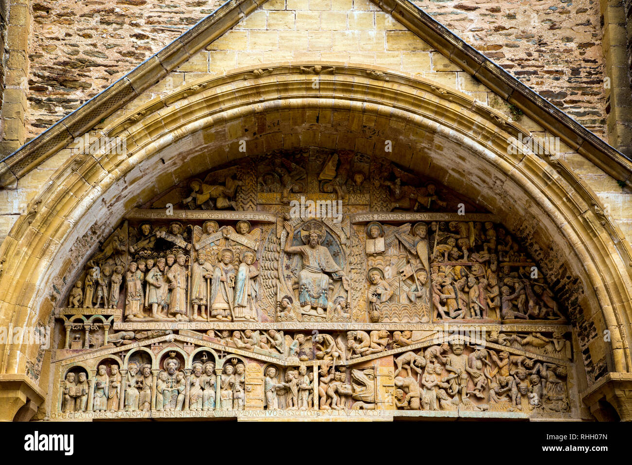 Romanesque carving of the Last Judgment in the tympanum over the main doors of Abbaye Sainte-Foy de Conques in France. Stock Photo
