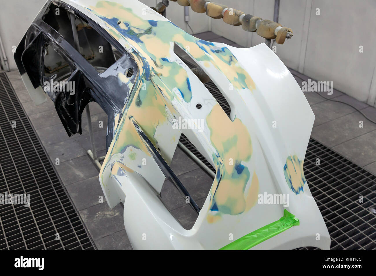 Repair of the rear bumper of a white car after an accident with the