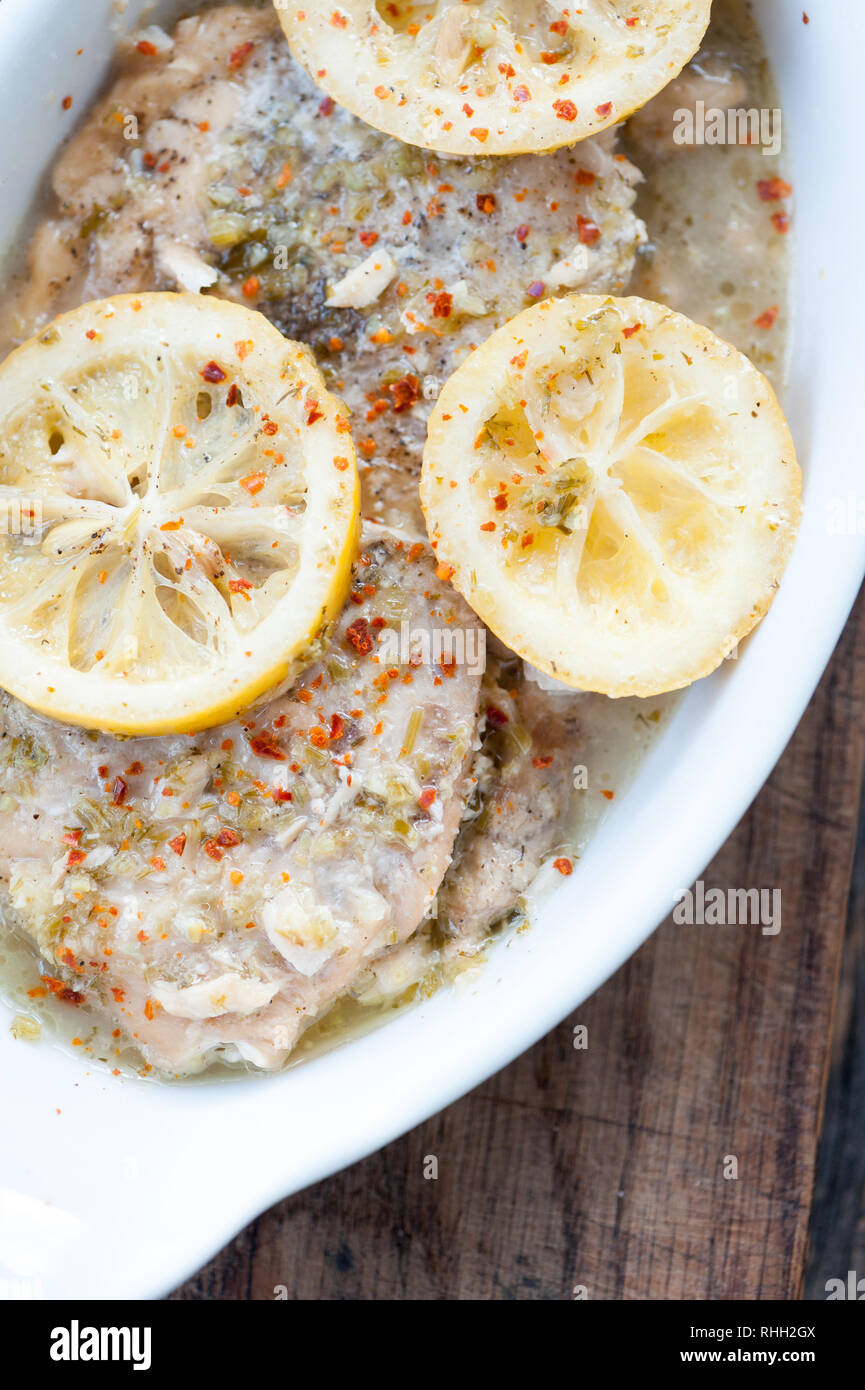 Baked fish fillet in butter and lemon sauce Stock Photo - Alamy