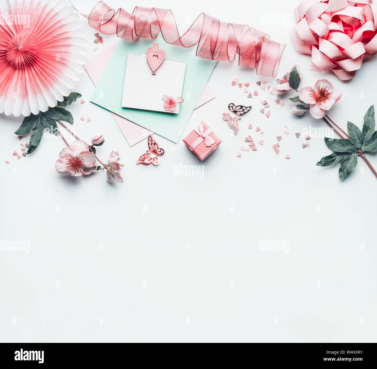 Beautiful background with greeting card mock up with pastel pink heart ,  flowers, party paper fan, ribbon and decoration, top view. Flat lay. Can  usin Stock Photo - Alamy