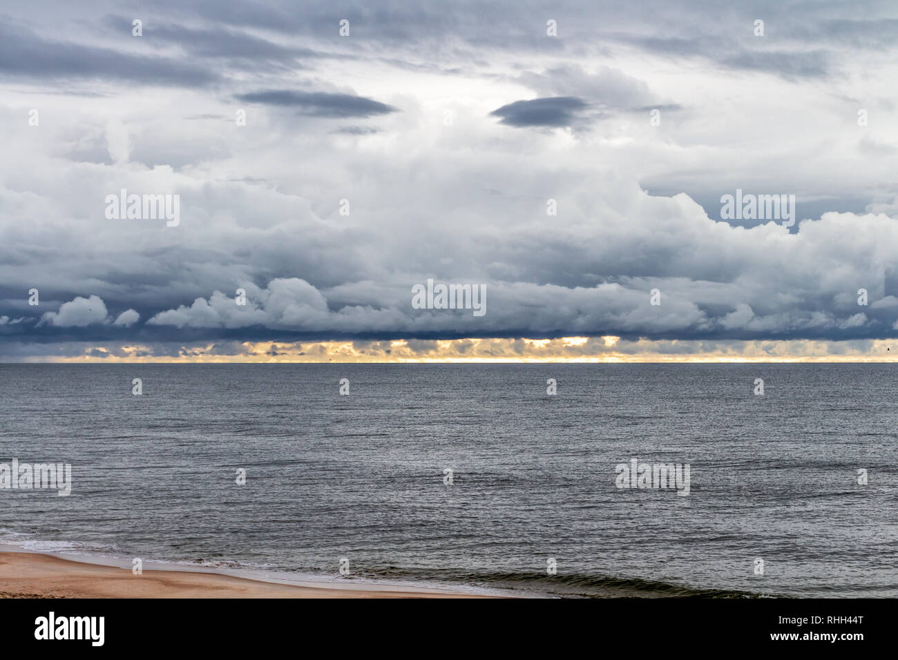 Curious cloud formation looking like a grimly monster above the Baltic Sea. Stock Photo