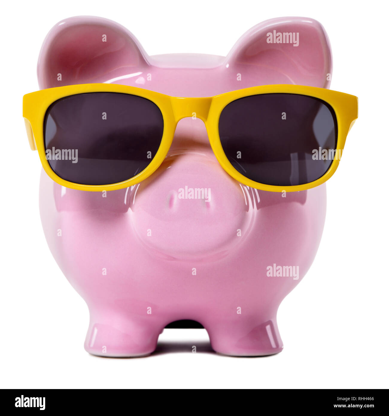 Pink piggy bank wearing yellow sunglasses. Stock Photo