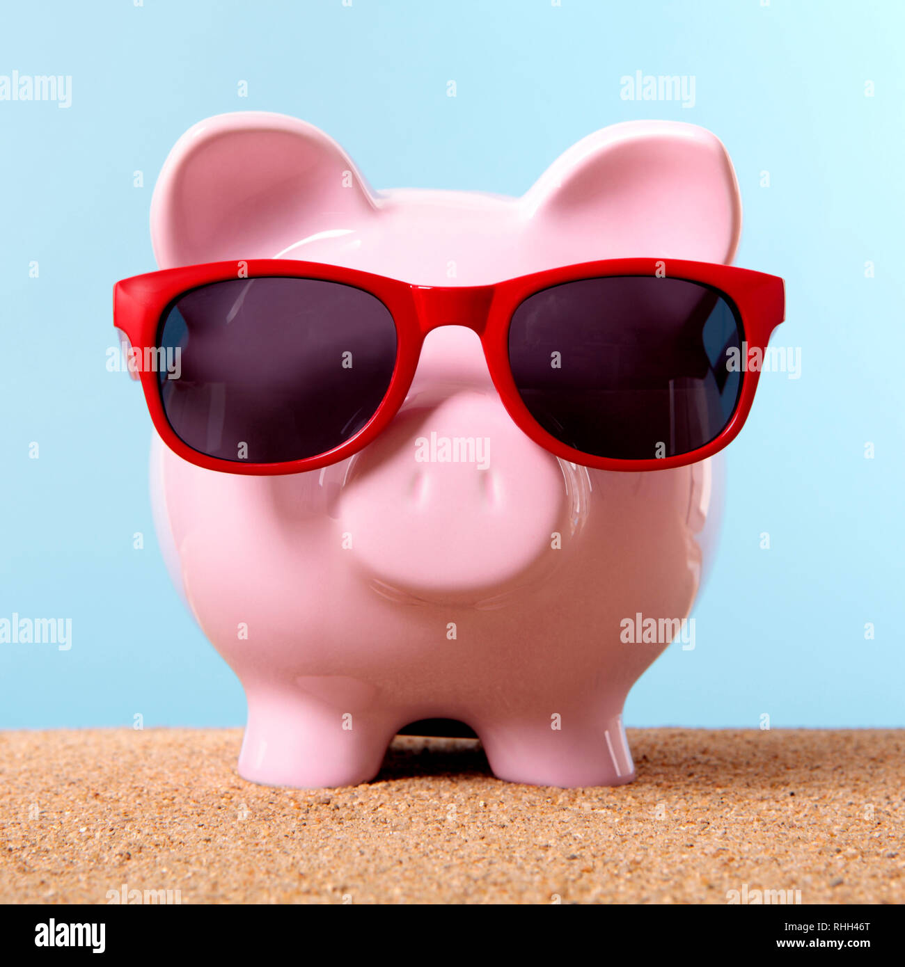 Pink piggy bank beach travel money Stock Photo