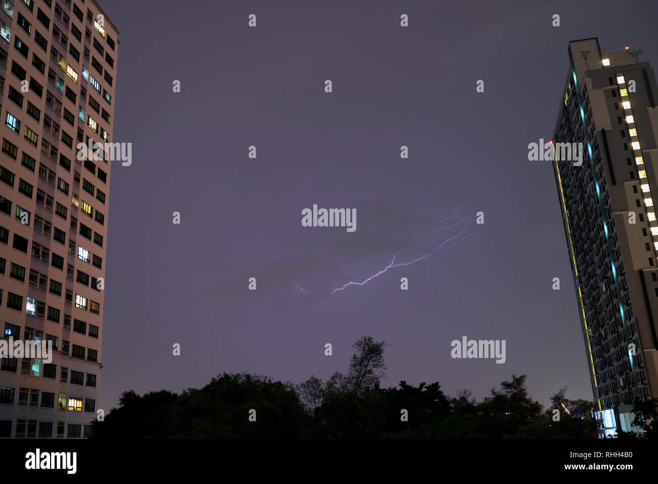 Real lightning flashing on the evening sky of Bangkok, Thailand Stock Photo