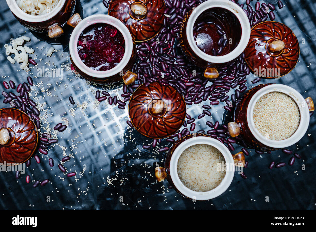 Carbohydrates. Grouts in brown bowls. Pasta, rice, barley, beans and