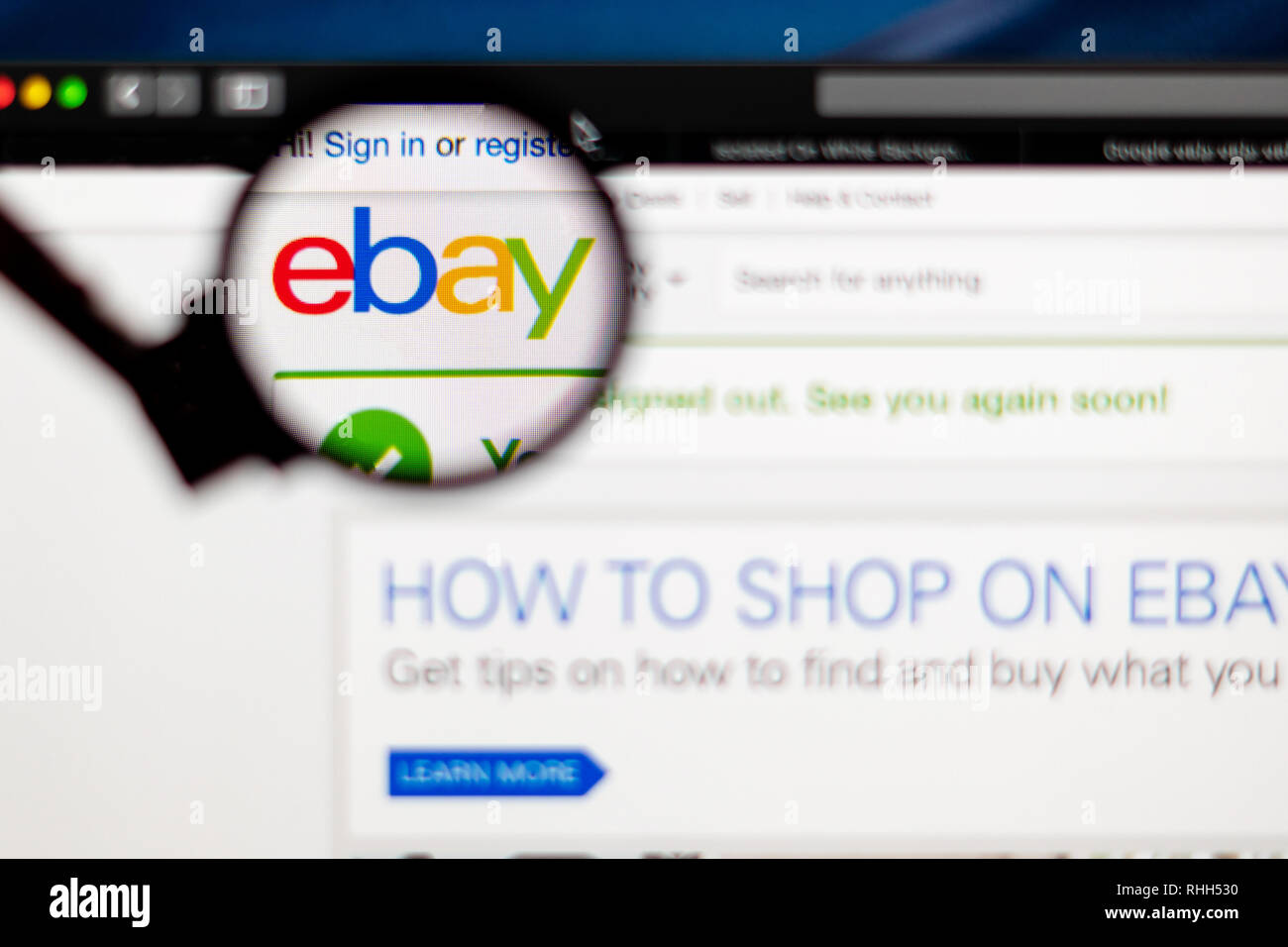 eBay website homepage. eBay company logo visible through a magnifying