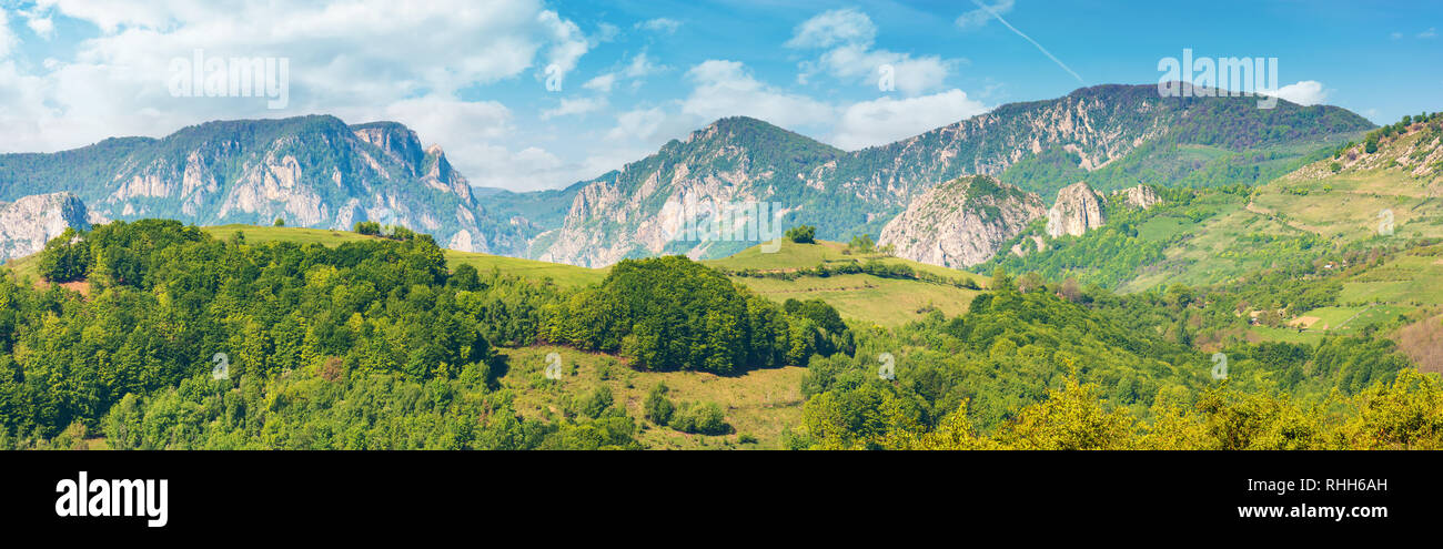 gorgeous panorama of countryside in springtime. beautiful landscape of romania. rural area on the near hills. distant ridge with rocks, cliffs and gor Stock Photo