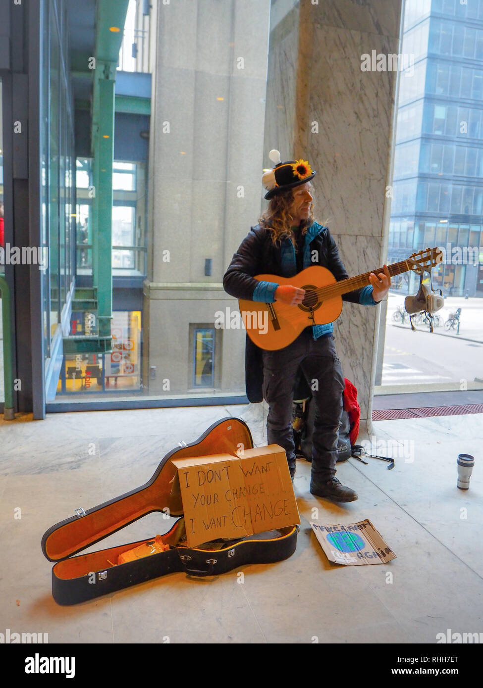 January 2019 - Brussels, Belgium: male street artist playing guitar during a climate change protest rally as a call to action Stock Photo