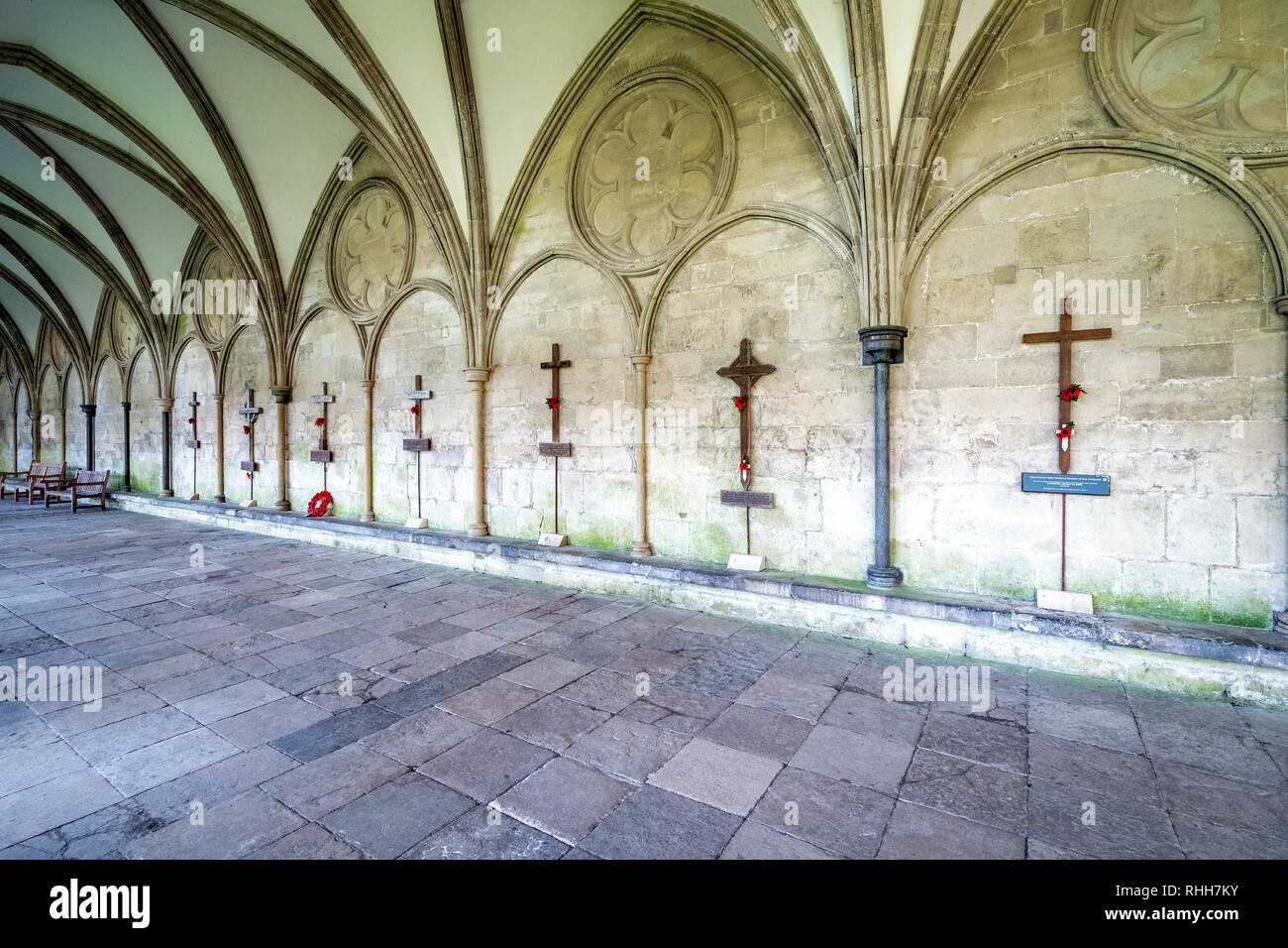 Row of wooden cross grave markers of fallen servicemen from various conflicts in the cloisters of Salisbury Cathedral Stock Photo