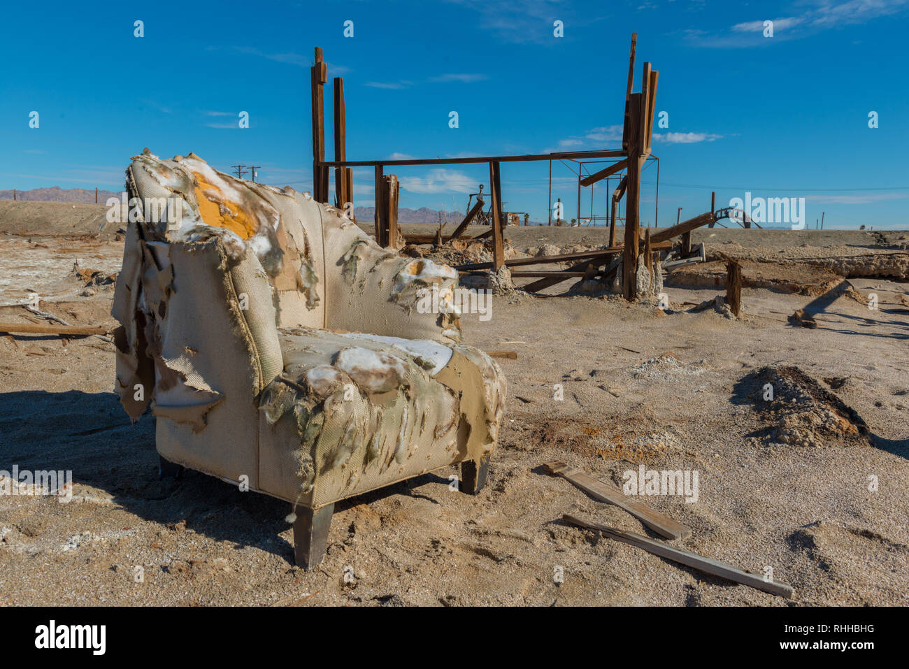 Couch in ruins of a house in Bombay Beach near the Salton Sea in California, USA Stock Photo